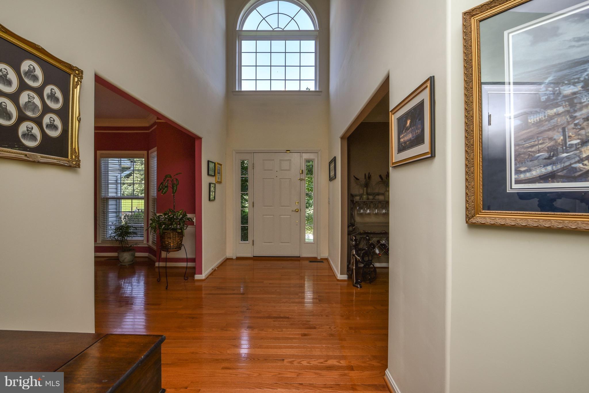 6865 North Stuart Road King George, VA 22485 - Photo 6 of 30 a view of a hallway with wooden floor and a living room