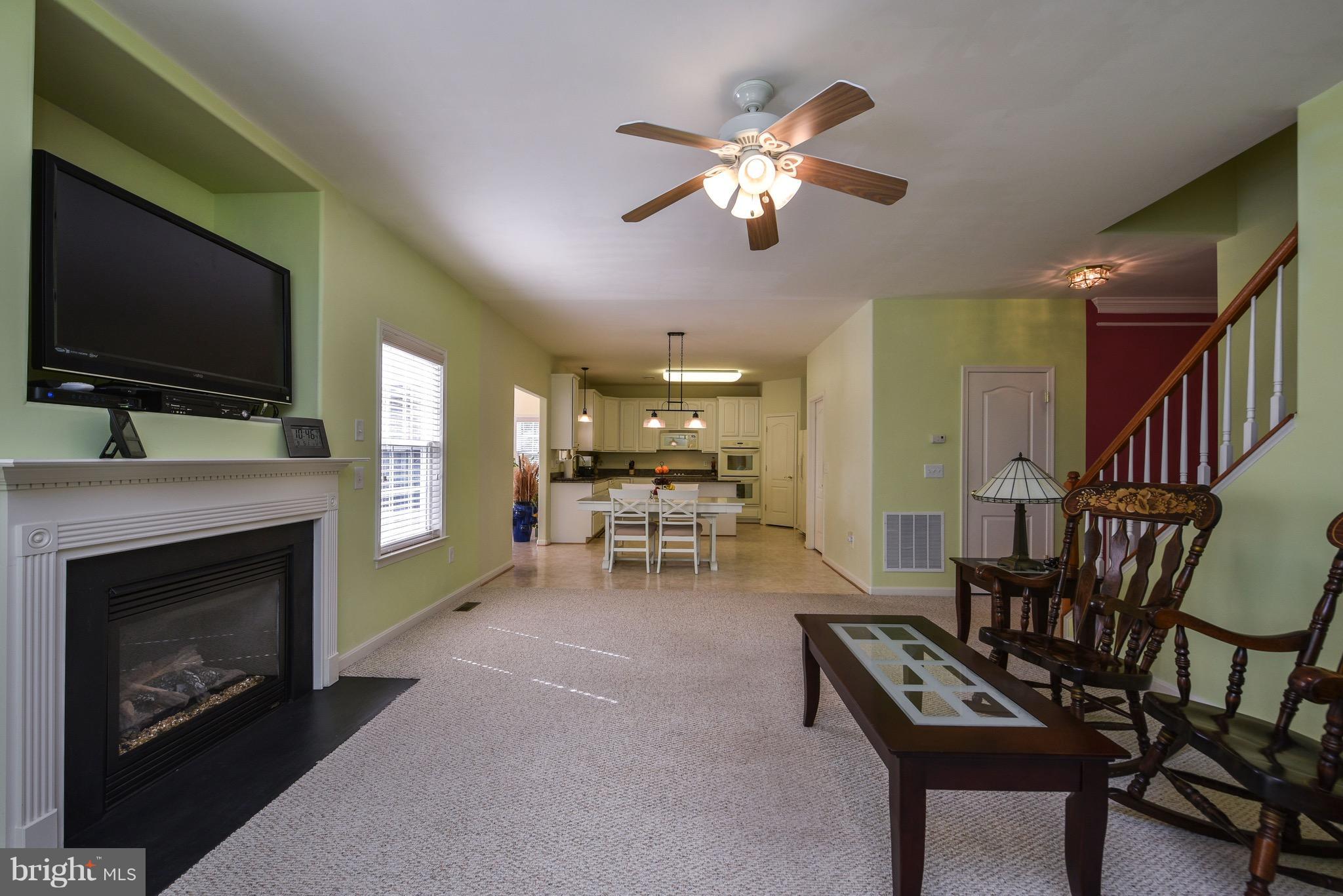 6865 North Stuart Road King George, VA 22485 - Photo 8 of 30 a living room with furniture a flat screen tv and a fireplace