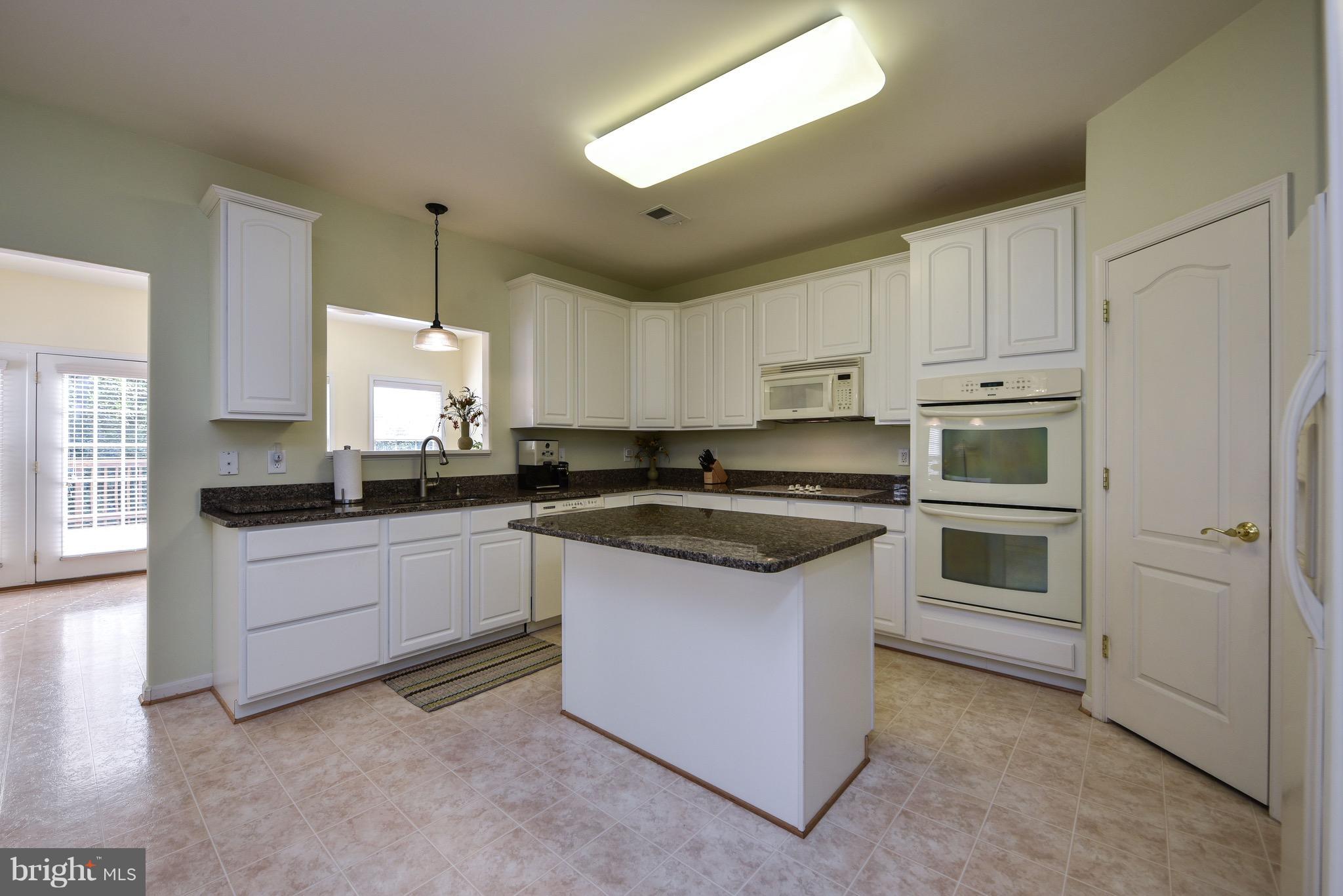 6865 North Stuart Road King George, VA 22485 - Photo 9 of 30 a kitchen with stainless steel appliances granite countertop a stove a sink and a refrigerator