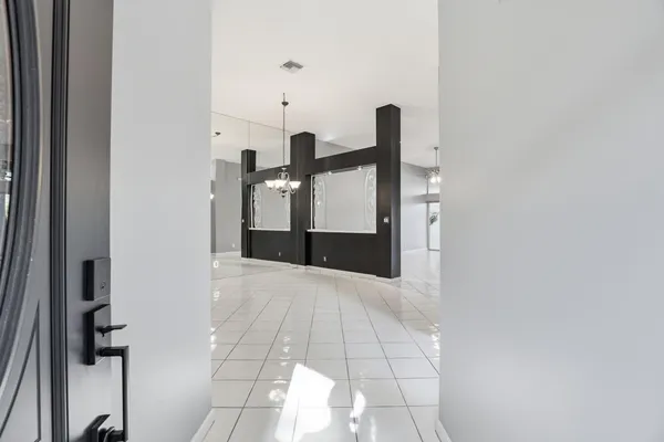 a view of a kitchen with a sink and a refrigerator