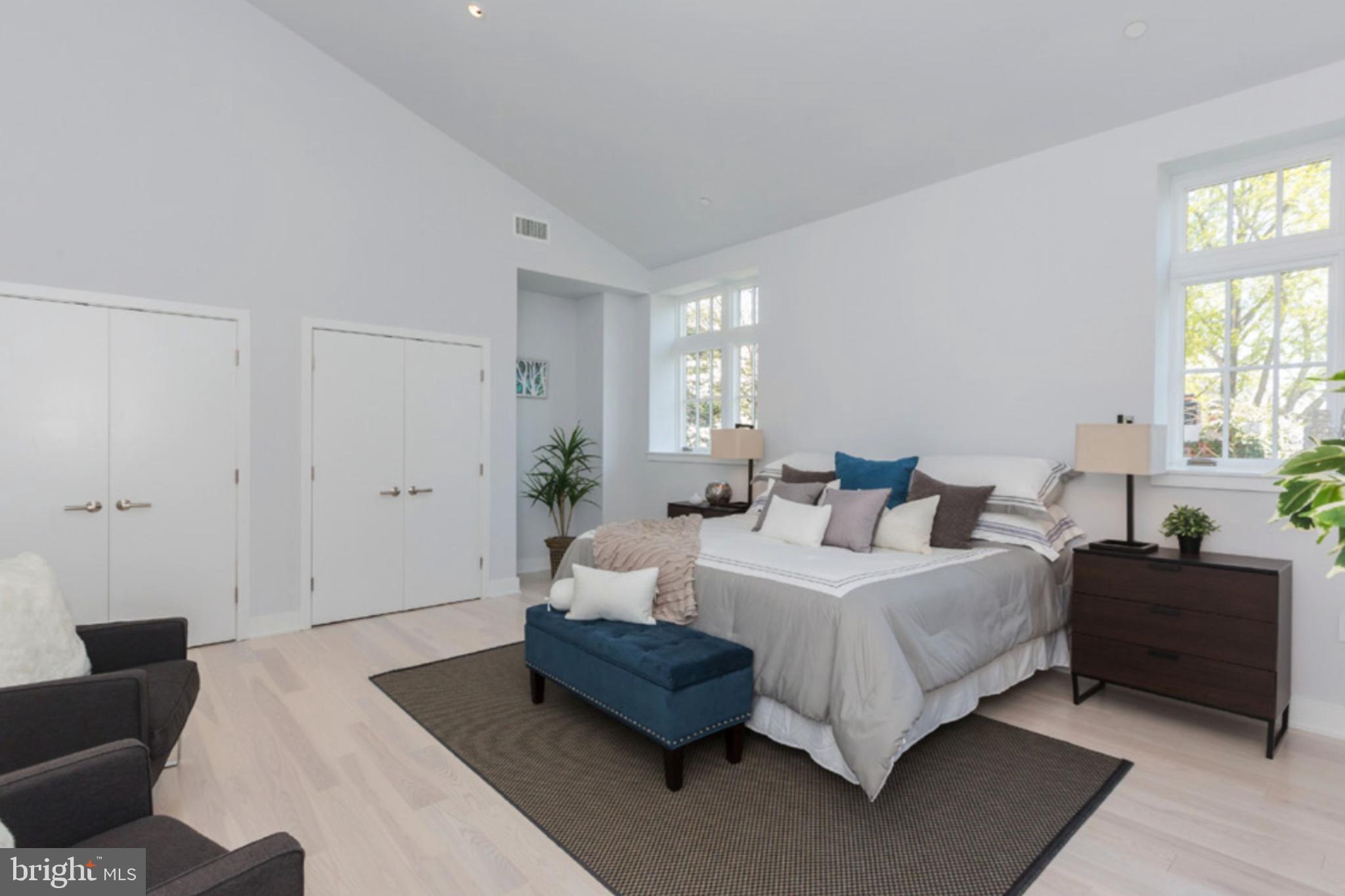 2709 N Street Northwest, Unit 102 Washington, DC 20007 - Photo 7 of 18 a spacious bedroom with a bed and a couch