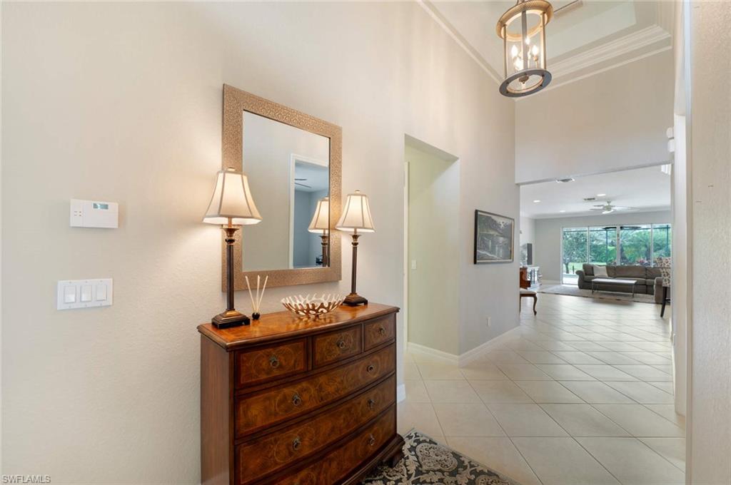 6549 Marbella Drive Naples, FL 34105 - Photo 2 of 28 a view of room with window and wooden floor