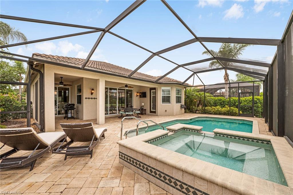 6549 Marbella Drive Naples, FL 34105 - Photo 21 of 28 a swimming pool with outdoor seating and a mirror