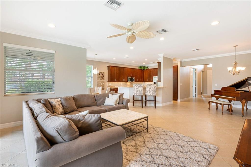 6549 Marbella Drive Naples, FL 34105 - Photo 5 of 28 a living room with furniture and kitchen view