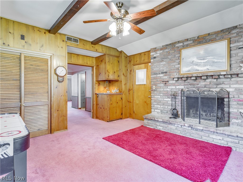 488 Harris Road Cleveland, OH 44143 - Photo 7 of 27 View of family room shows wet bar, wood burning fireplace and door to the covered patio and back yard.