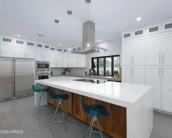 a kitchen with a table chairs sink and cabinets