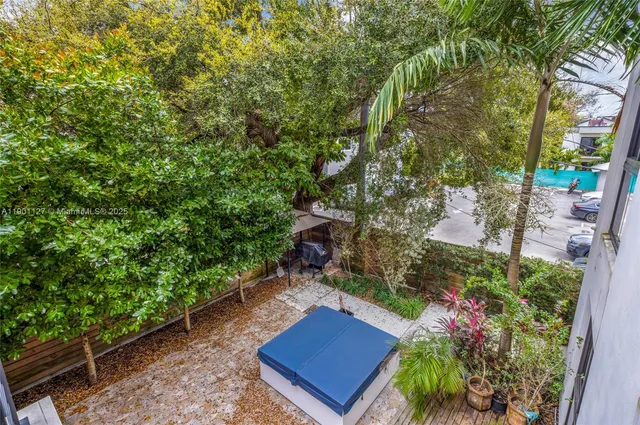 an aerial view of a house with garden space and street view