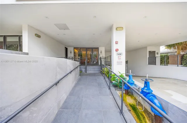 a living room with a bed and a potted plant