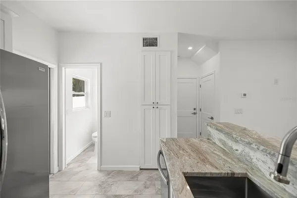 a bedroom with a bed and a sink