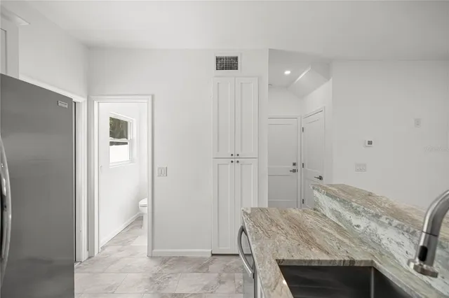 a bedroom with a bed and a sink