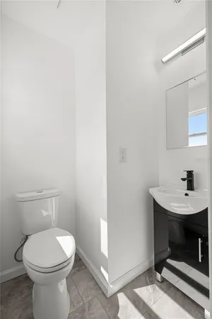 a bathroom with a toilet a sink and a mirror