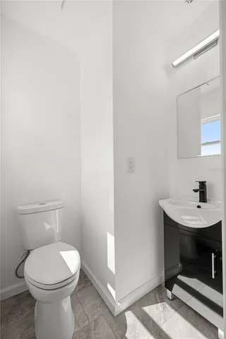 a bathroom with a toilet a sink and a mirror