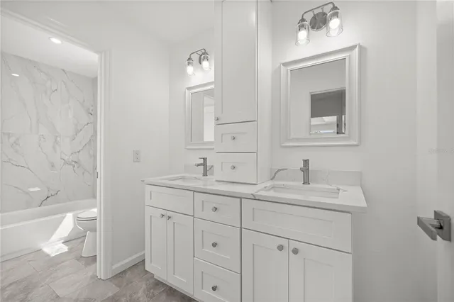 a bathroom with a toilet a sink and a mirror