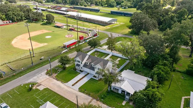 an aerial view of a house with a garden and swimming pool