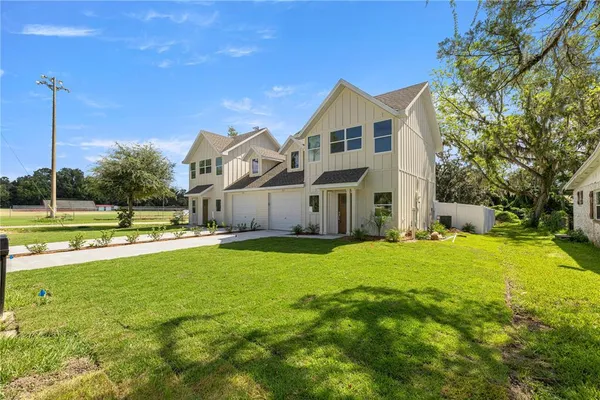 a view of a house with swimming pool and a yard