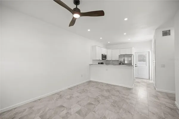 a view of kitchen with white cabinets and wooden floor