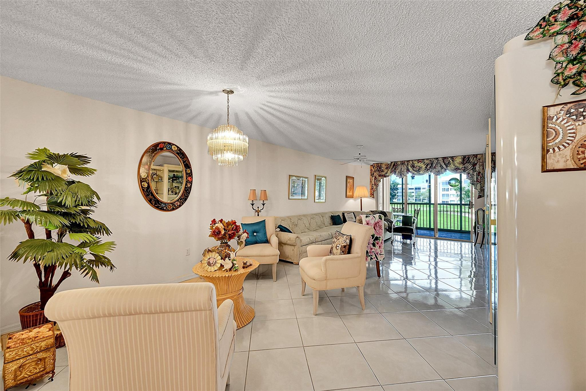 2541 North Nob Hill Road, Unit 206 Sunrise, FL 33322 - Photo 1 of 44 a living room with furniture a clock and a window