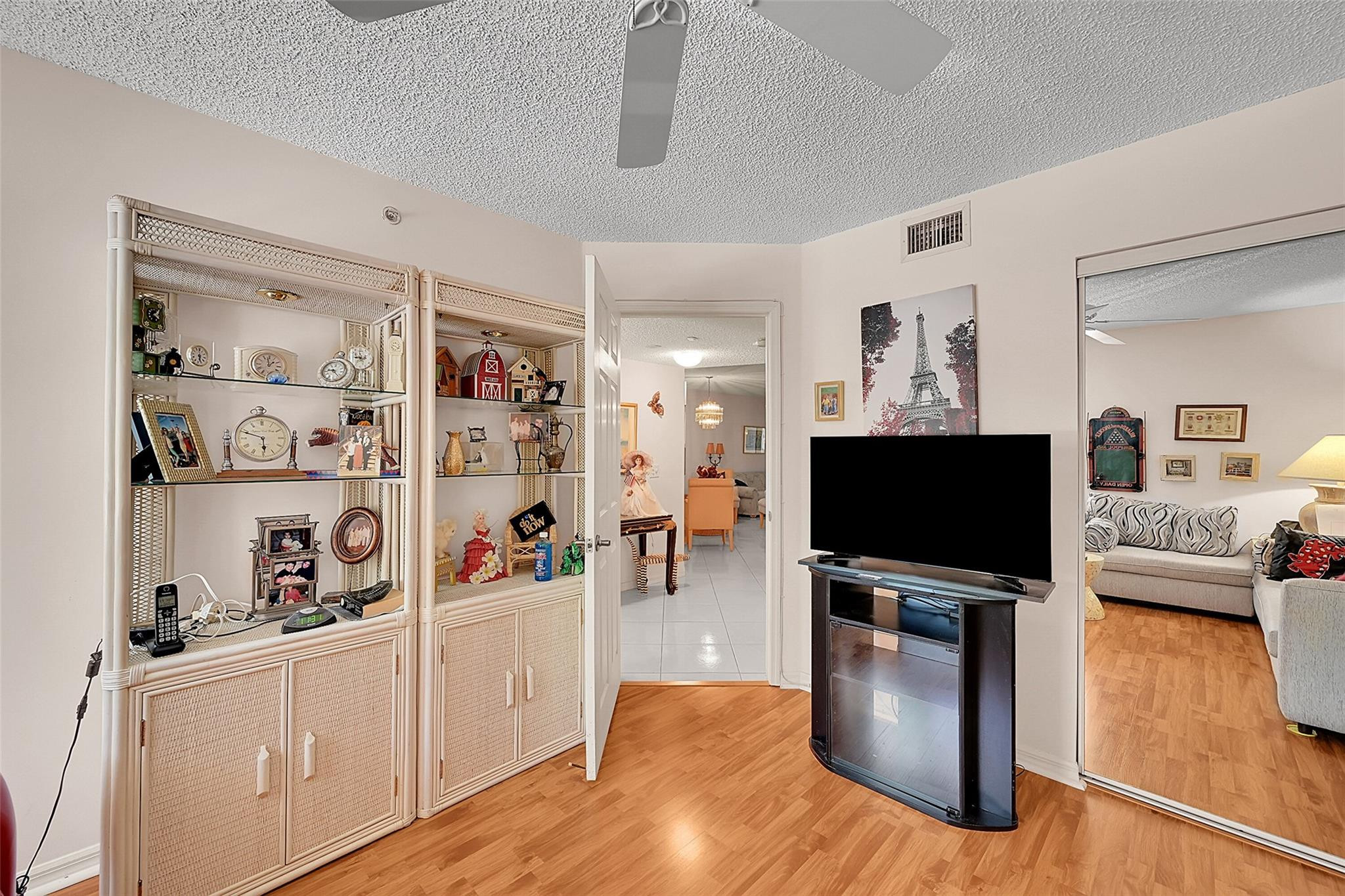 2541 North Nob Hill Road, Unit 206 Sunrise, FL 33322 - Photo 11 of 44 a living room with furniture and a flat screen tv