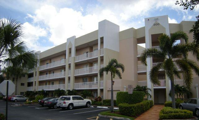 2541 North Nob Hill Road, Unit 206 Sunrise, FL 33322 - Photo 16 of 44 a couple of cars parked in front of a building