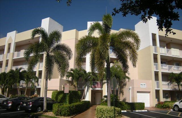 2541 North Nob Hill Road, Unit 206 Sunrise, FL 33322 - Photo 20 of 44 a view of a palm trees in front of a building
