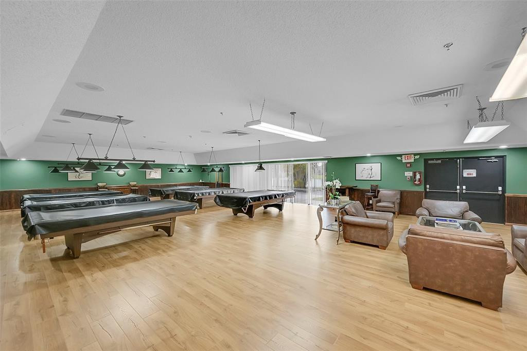2541 North Nob Hill Road, Unit 206 Sunrise, FL 33322 - Photo 22 of 44 a living room with furniture and a wooden floor