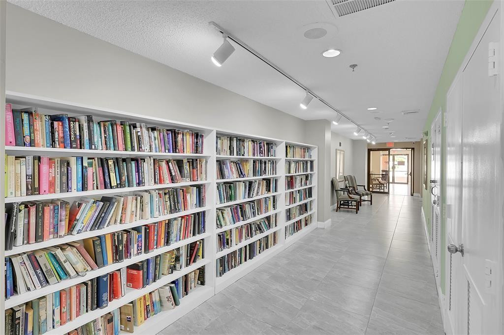 2541 North Nob Hill Road, Unit 206 Sunrise, FL 33322 - Photo 29 of 44 a hallway with a book shelf and a book shelf