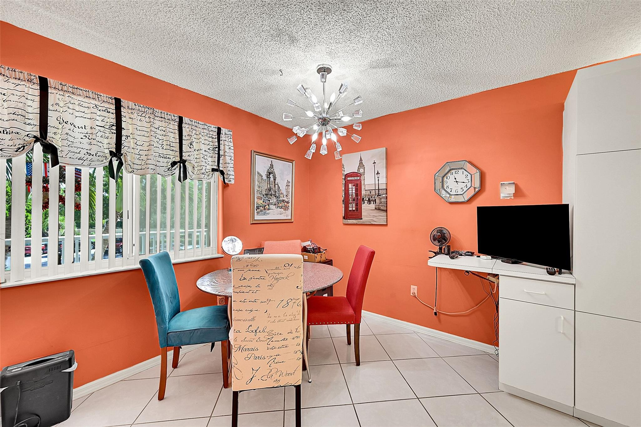 2541 North Nob Hill Road, Unit 206 Sunrise, FL 33322 - Photo 3 of 44 a view of a dining room with furniture and a chandelier