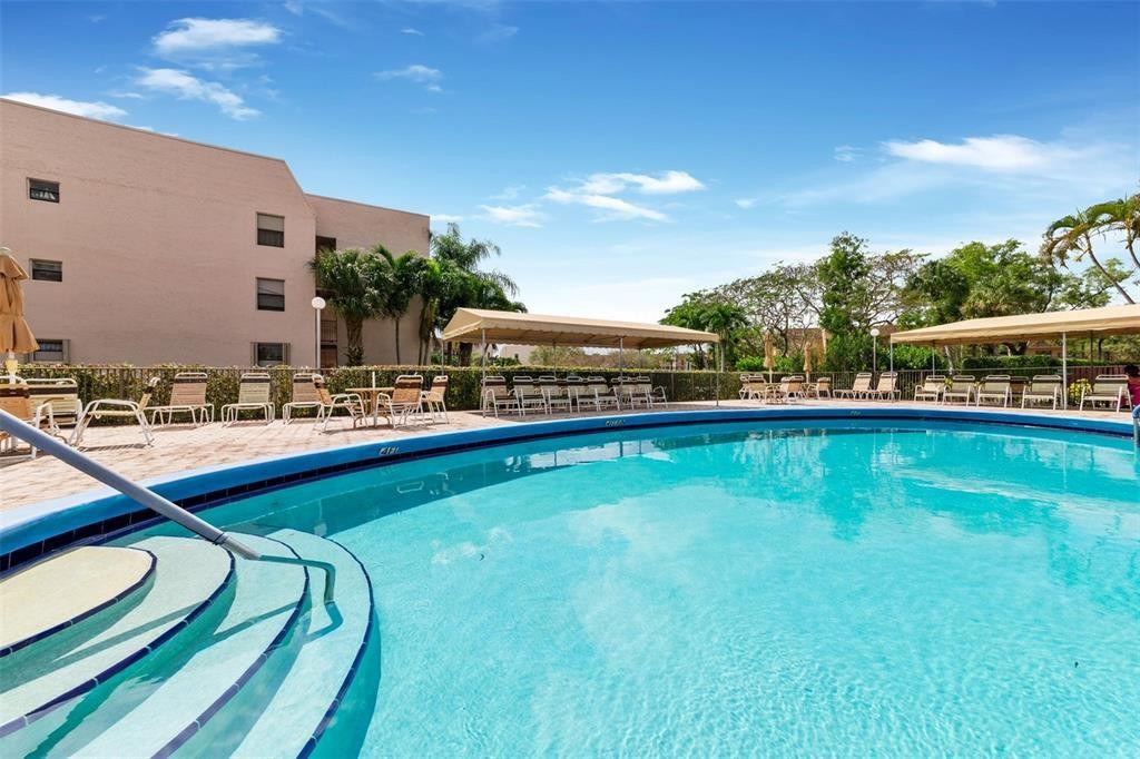 2541 North Nob Hill Road, Unit 206 Sunrise, FL 33322 - Photo 35 of 44 a view of swimming pool with outdoor seating and yard in back