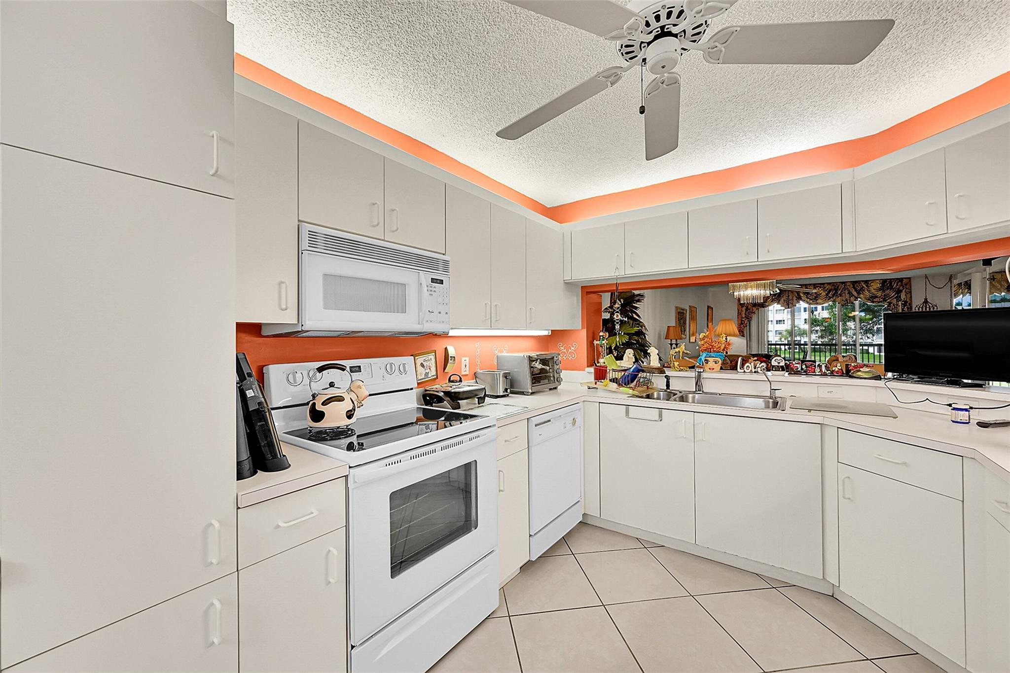 2541 North Nob Hill Road, Unit 206 Sunrise, FL 33322 - Photo 5 of 44 a kitchen with white cabinets and appliances