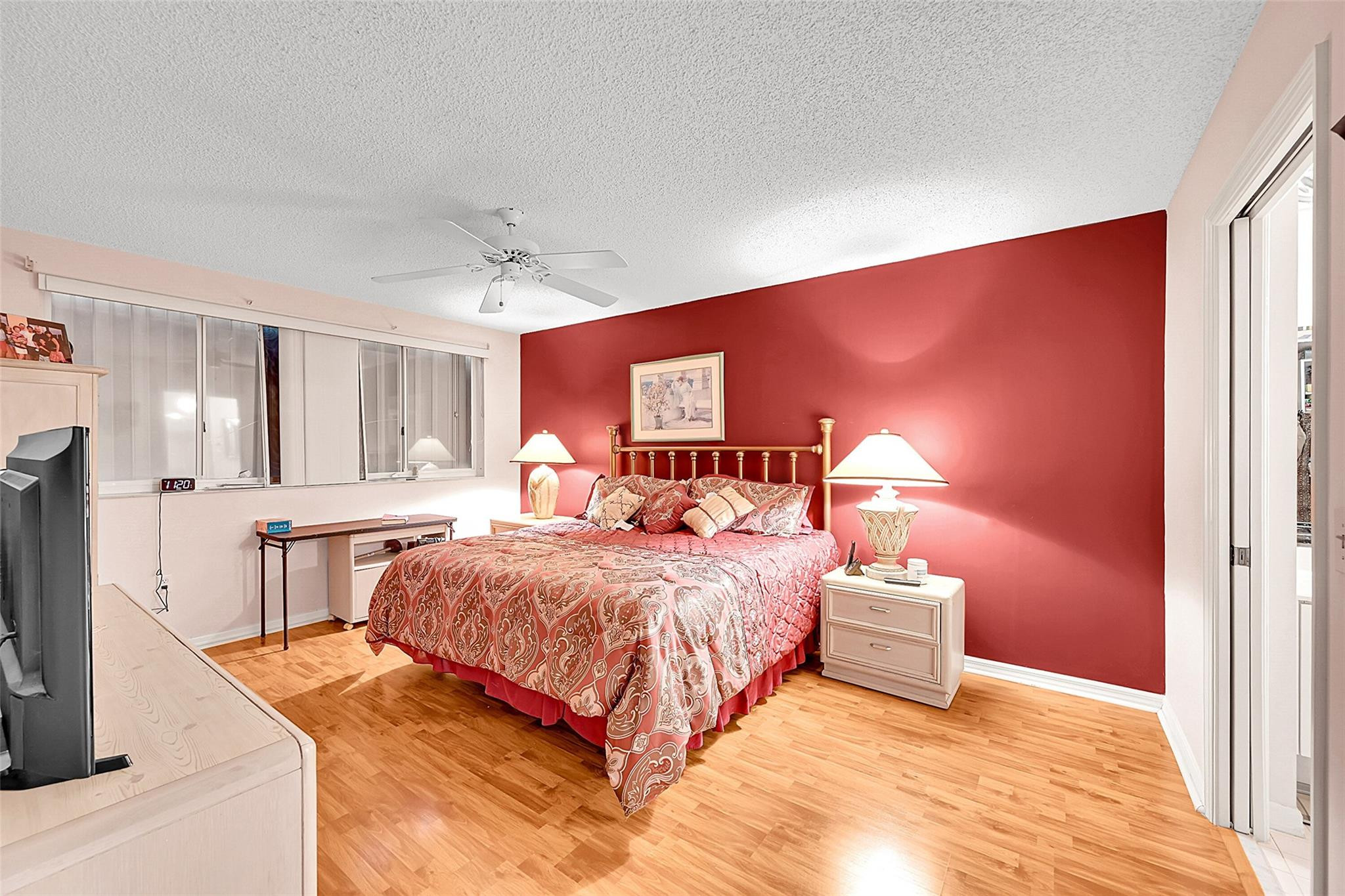 2541 North Nob Hill Road, Unit 206 Sunrise, FL 33322 - Photo 6 of 44 a spacious bedroom with a bed and a flat screen tv