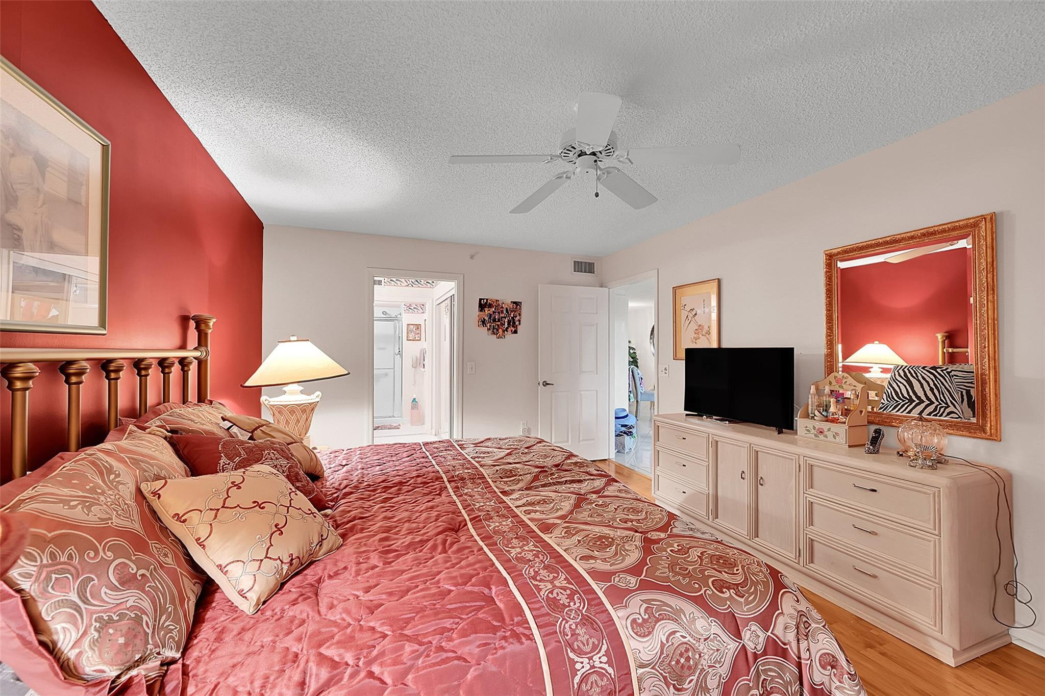 2541 North Nob Hill Road, Unit 206 Sunrise, FL 33322 - Photo 7 of 44 a bedroom with a bed and a flat screen tv