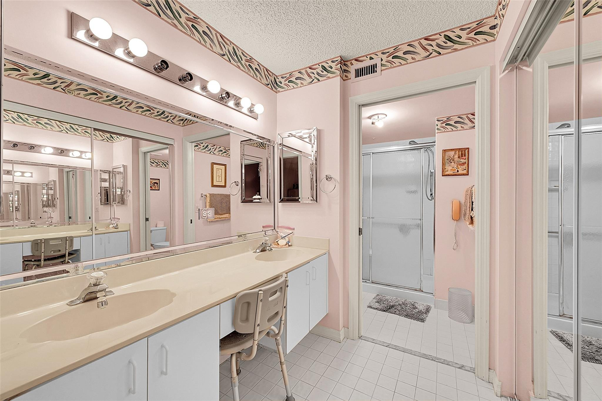 2541 North Nob Hill Road, Unit 206 Sunrise, FL 33322 - Photo 8 of 44 a spacious bathroom with a double vanity sink mirror and shower