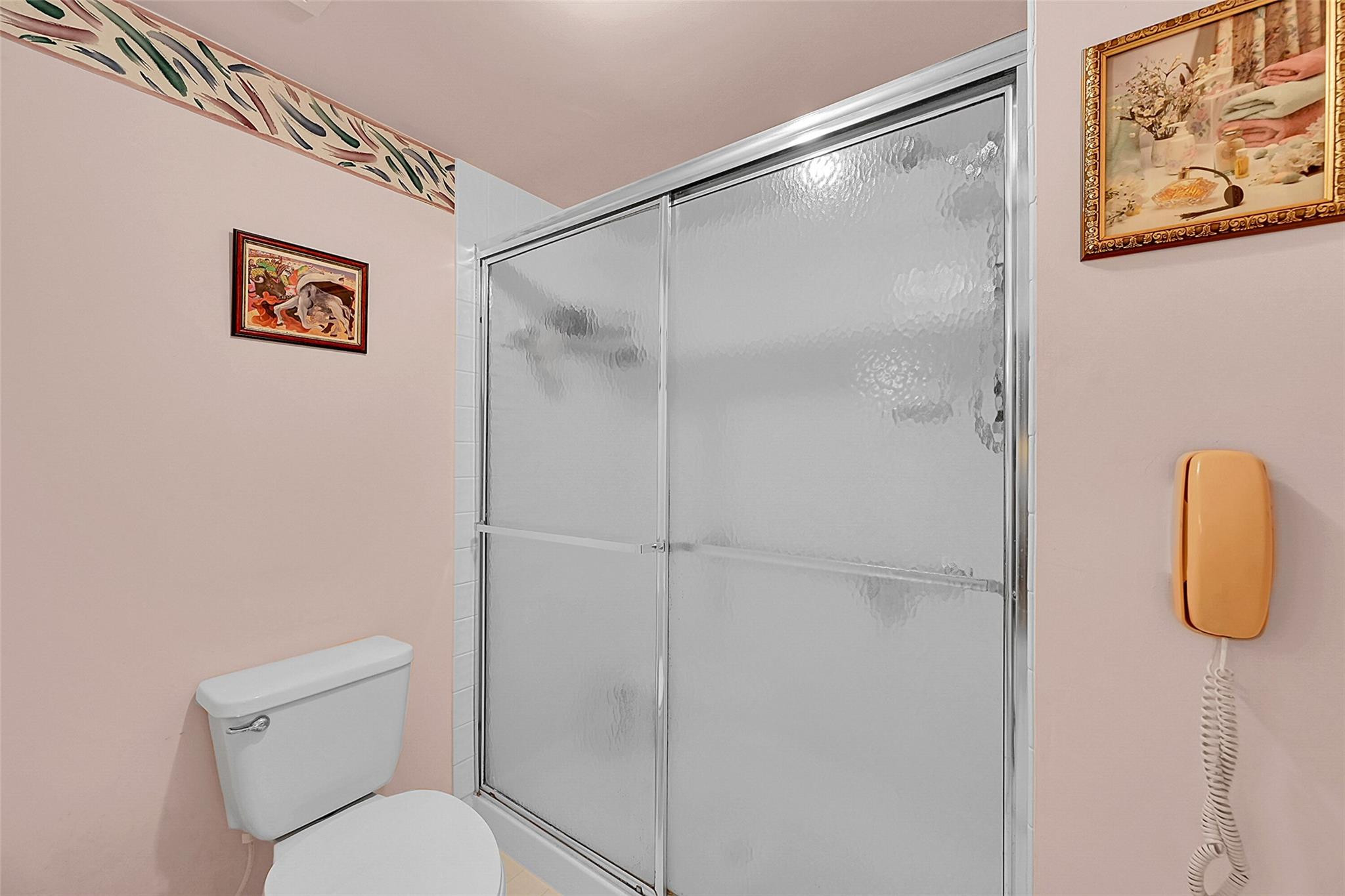 2541 North Nob Hill Road, Unit 206 Sunrise, FL 33322 - Photo 9 of 44 a bathroom with a shower and toilet