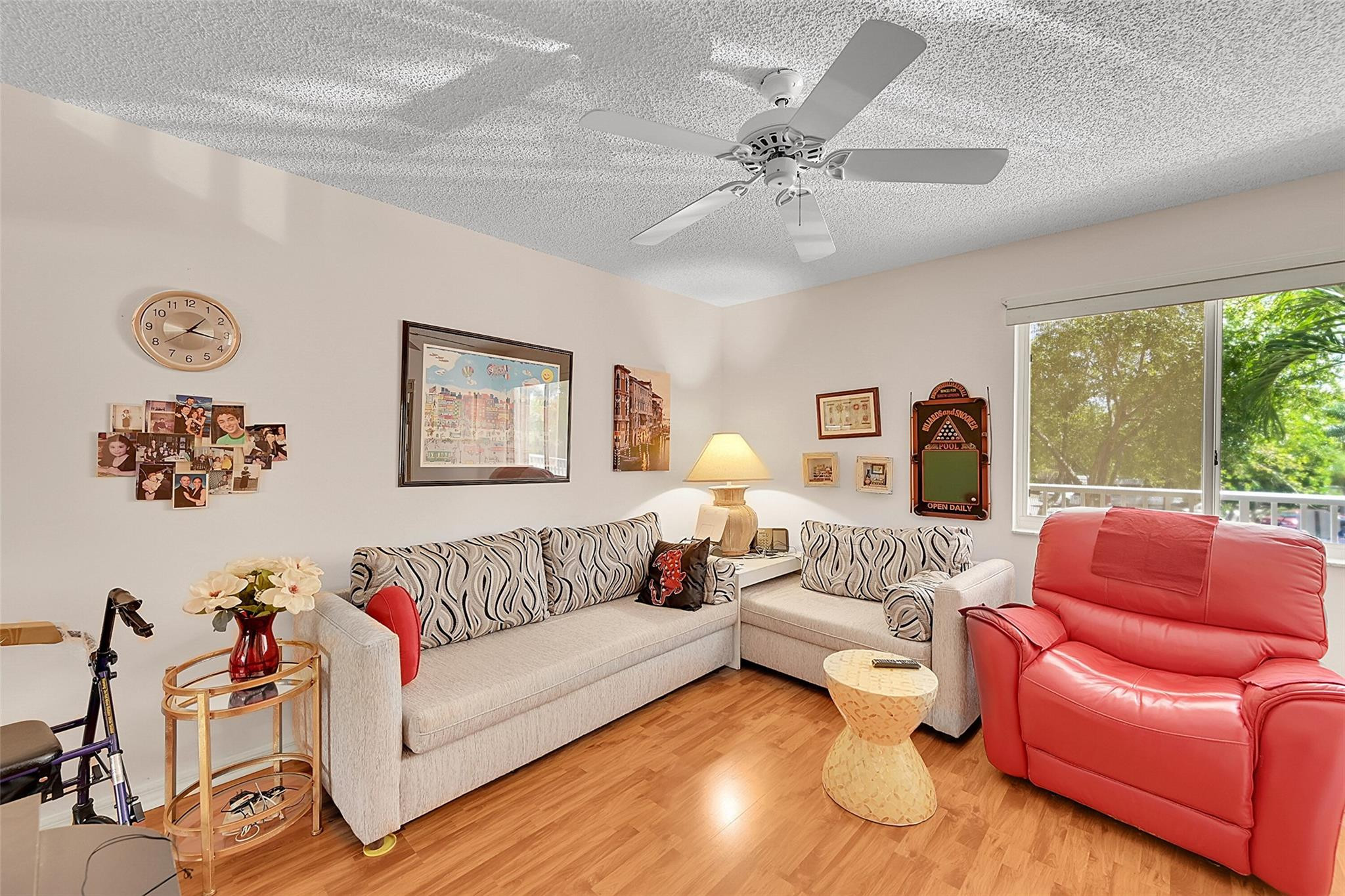 2541 North Nob Hill Road, Unit 206 Sunrise, FL 33322 - Photo 10 of 44 a living room with furniture and a large window
