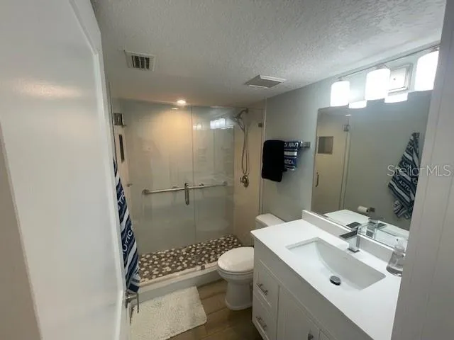 a bathroom with a sink toilet and shower