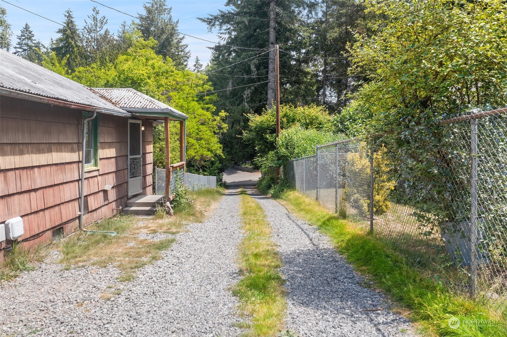 2515 Rocky Point Road Northwest Bremerton, WA 98312 - Photo 21 of 29 a view of a small house with wooden fence
