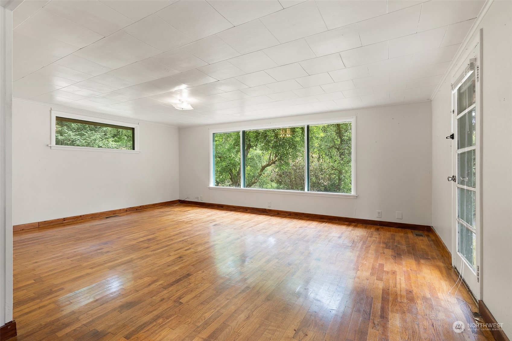 2515 Rocky Point Road Northwest Bremerton, WA 98312 - Photo 6 of 29 a view of an empty room with wooden floor and a window
