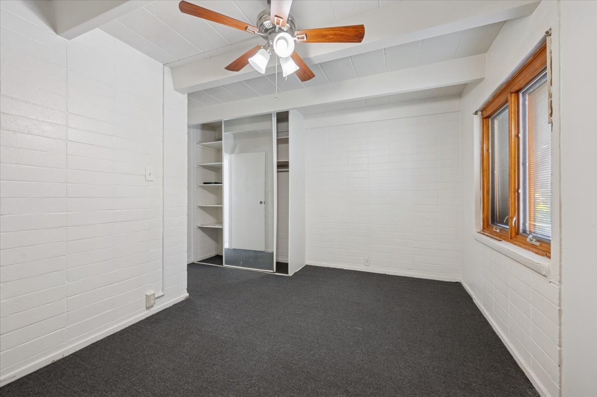 1140 West Lunt Avenue, Unit 1B Chicago, IL 60626 - Photo 11 of 13 an empty room with windows and fan