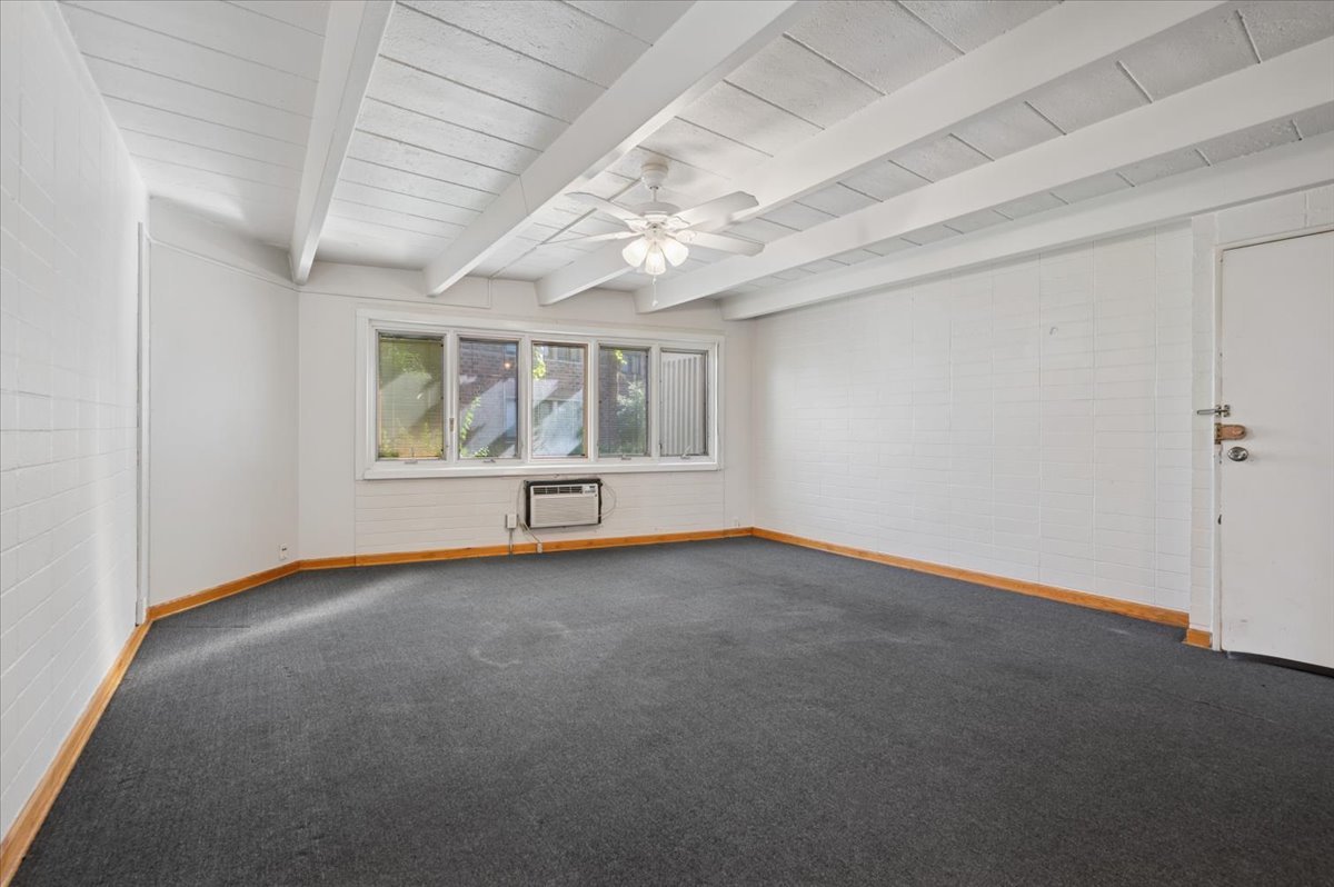 1140 West Lunt Avenue, Unit 1B Chicago, IL 60626 - Photo 3 of 13 an empty room with windows