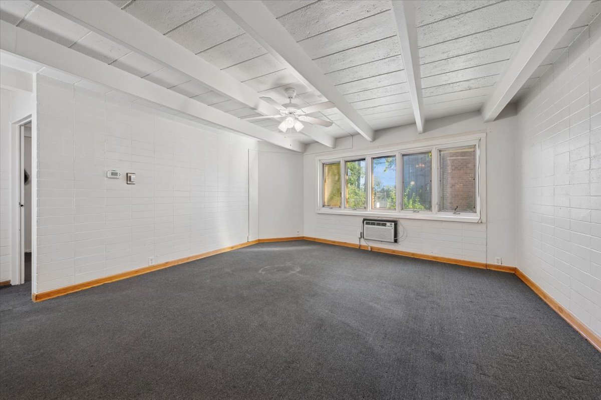 1140 West Lunt Avenue, Unit 1B Chicago, IL 60626 - Photo 4 of 13 an empty room with windows