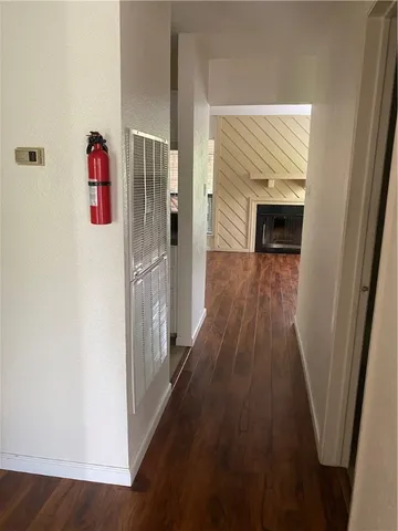 a hallway with sliding door and front door