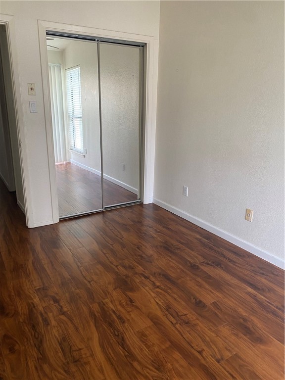 612 Park Place, Unit 301 Austin, TX 78705 - Photo 20 of 25 a view of an empty room with wooden floor and a mirror
