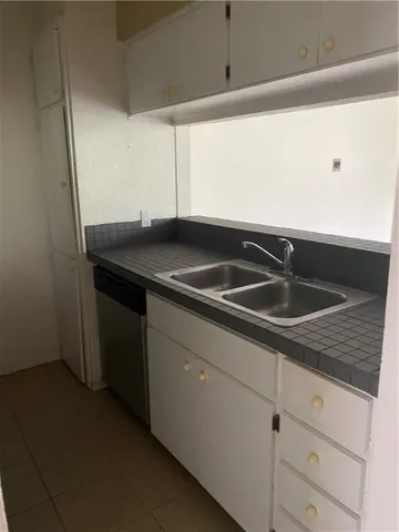 a kitchen with a sink and cabinets