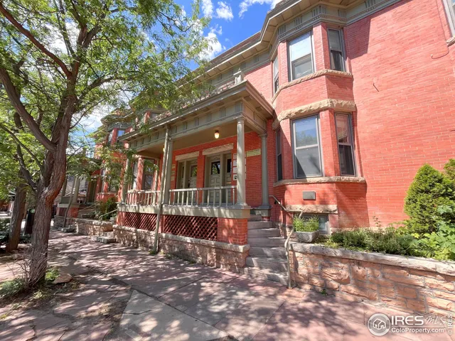 a view of a brick building with many windows
