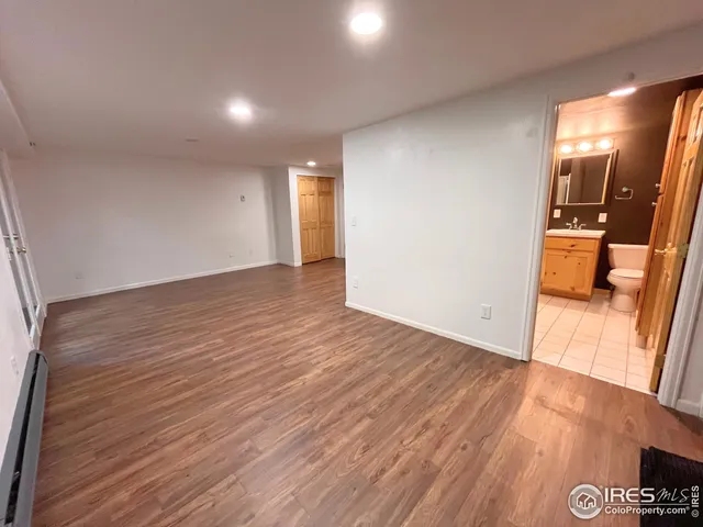 a view of a room with wooden floor