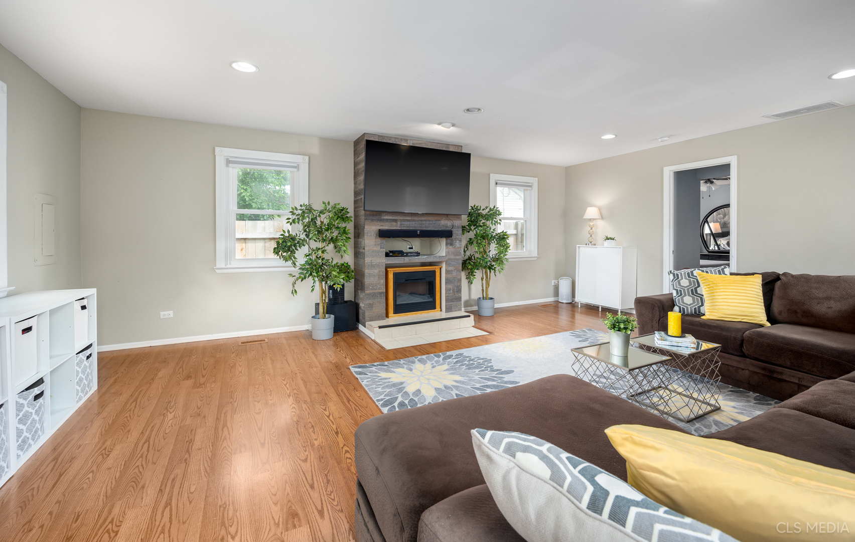 110 Cedar Circle Streamwood, IL 60107 - Photo 11 of 28 a living room with furniture a flat screen tv and a fireplace