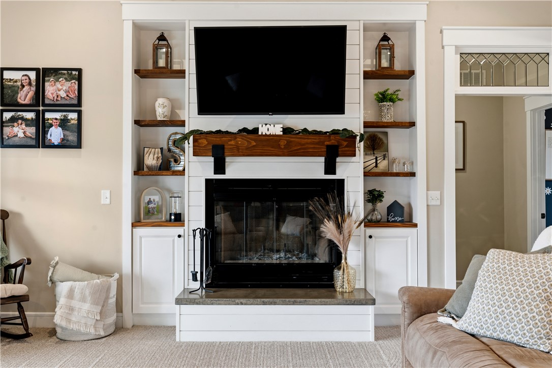 1158 Pyle Road Clarksville, OH 45113 - Photo 17 of 76 This inviting living space showcases a prominent woodburning fireplace feature, creating a cozy and central gathering area.