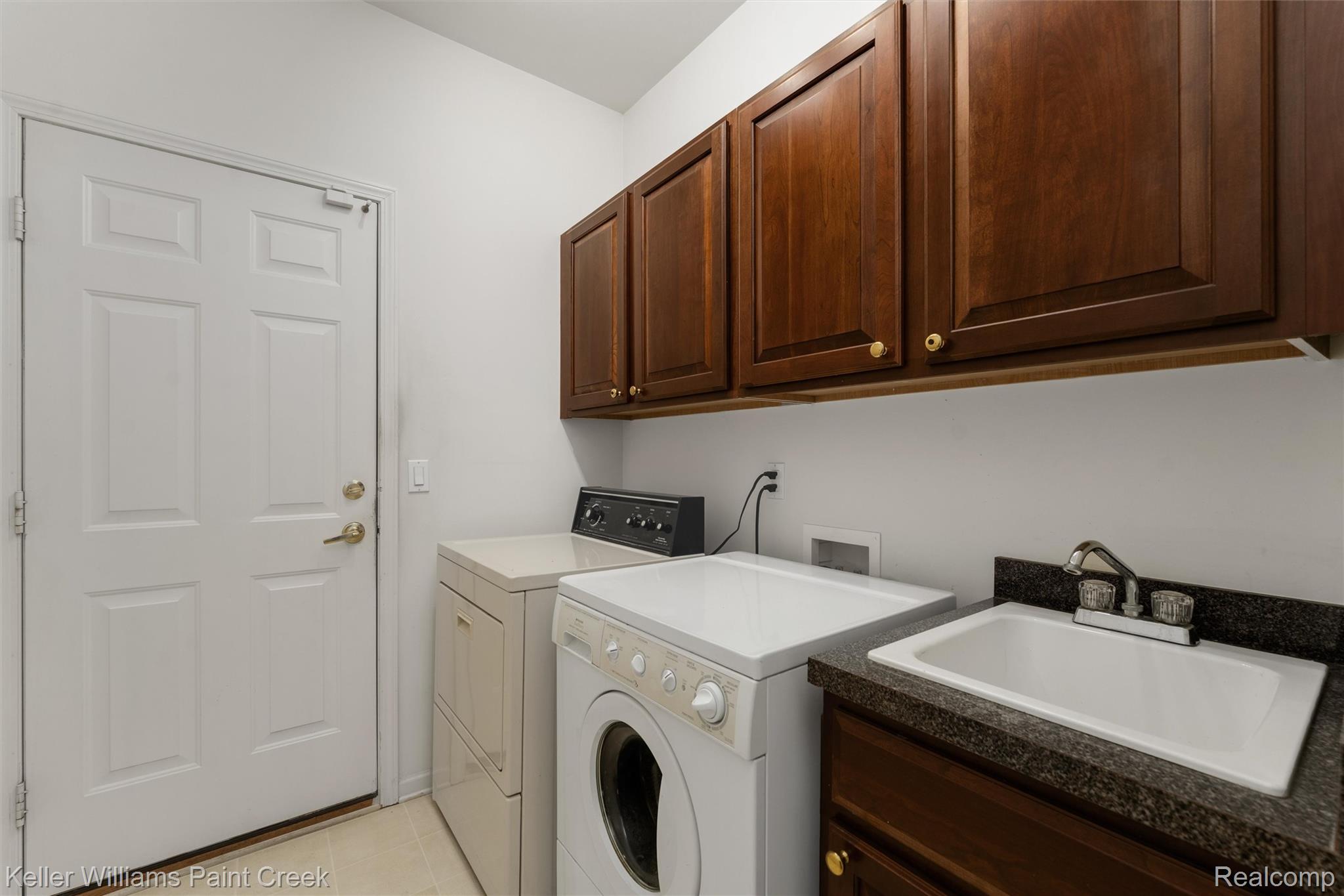 1685 Maple Creek Court Rochester, MI 48306 - Photo 16 of 49 Laundry area featuring independent washer and dryer and cabinet space