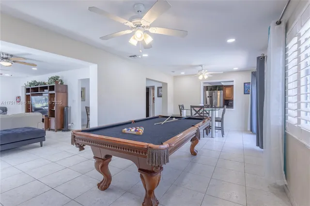 a room with furniture and pool table