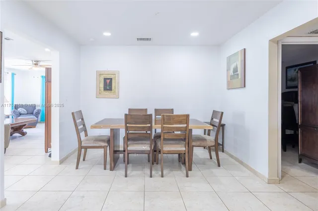 a dining room with a table and chairs